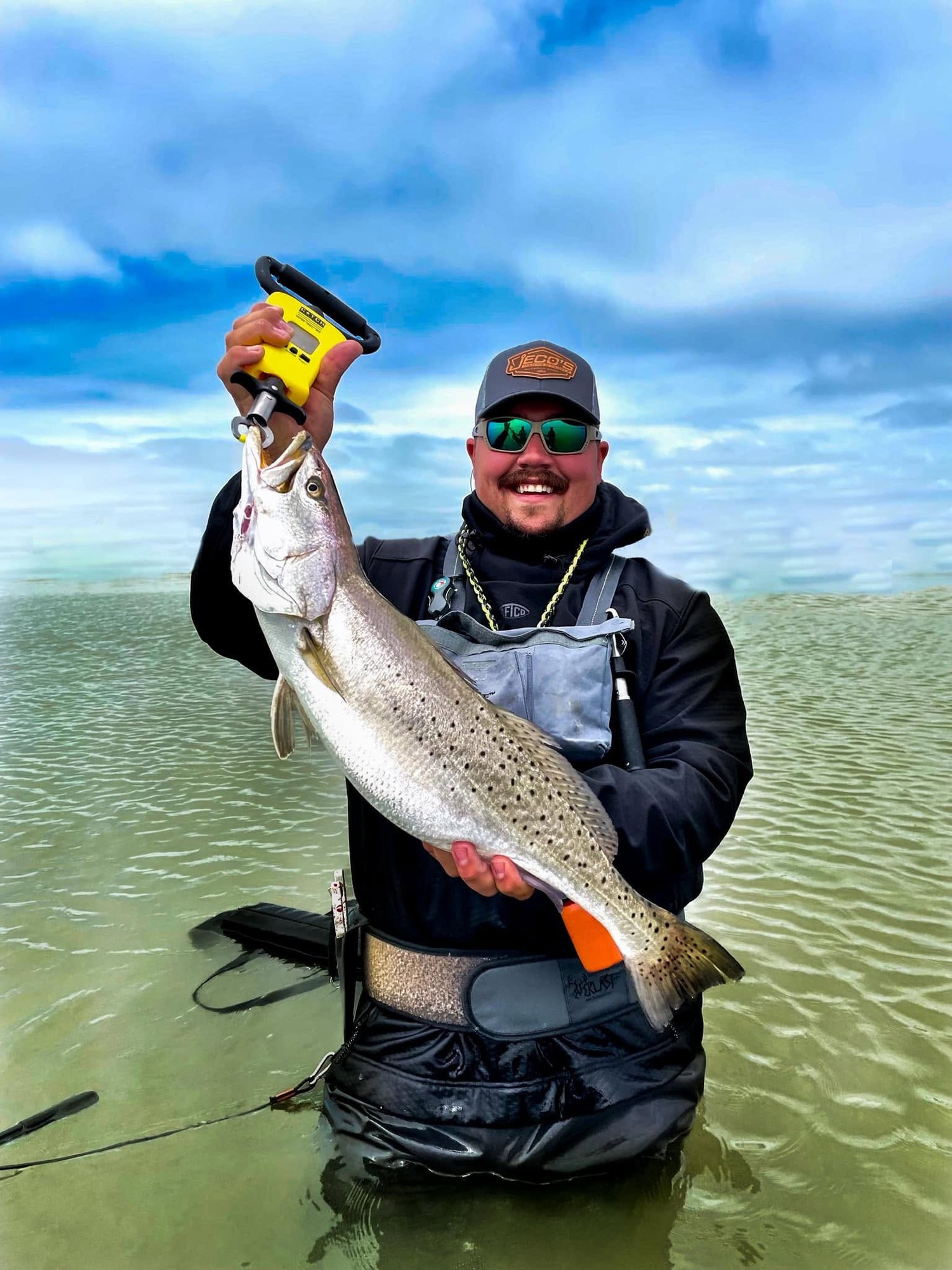 Angler holding a speckled trout during a Port O'Connor bay trip